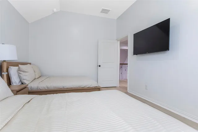 a living room with a flat screen tv and a wall painting