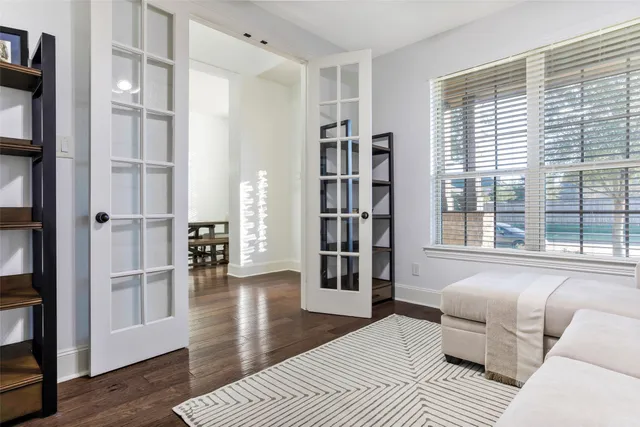 a spacious bedroom with a bed and a large window