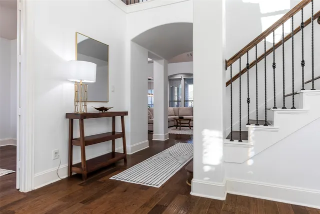 a view of entryway and hall with wooden floor