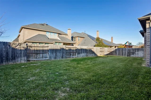 a view of a house with a yard and deck