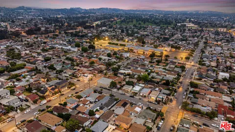 an aerial view of residential house with parking and mountain view