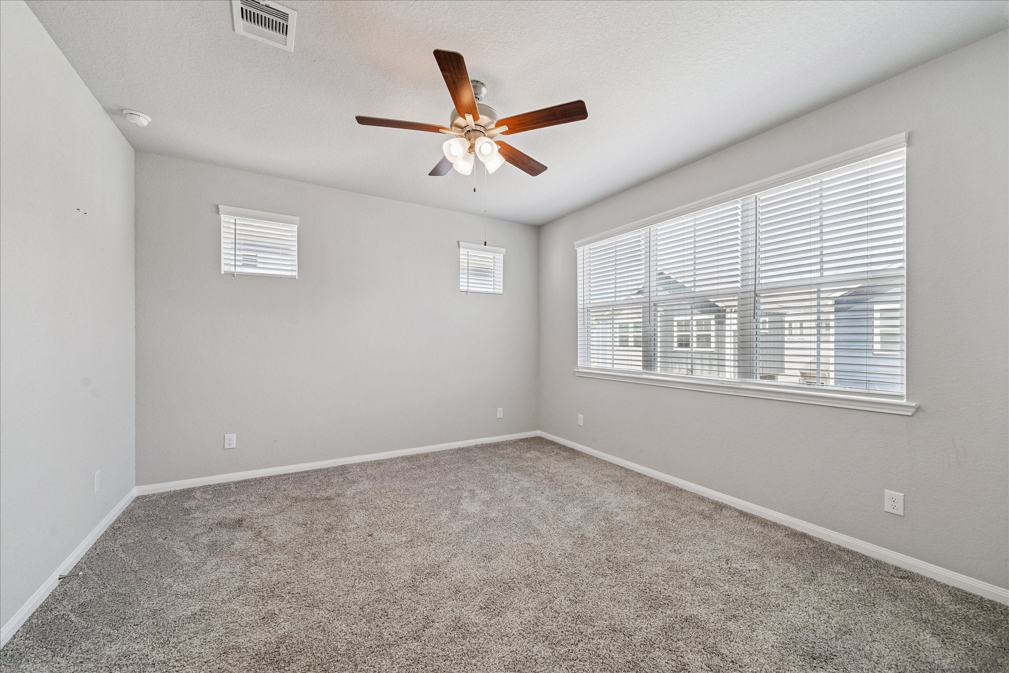 5502 Cuerta Street Houston, TX 77023 - Photo 11 of 25 Primary bedroom number one located upstairs. Plenty of natural light, a neutral color palette, and plush carpet.