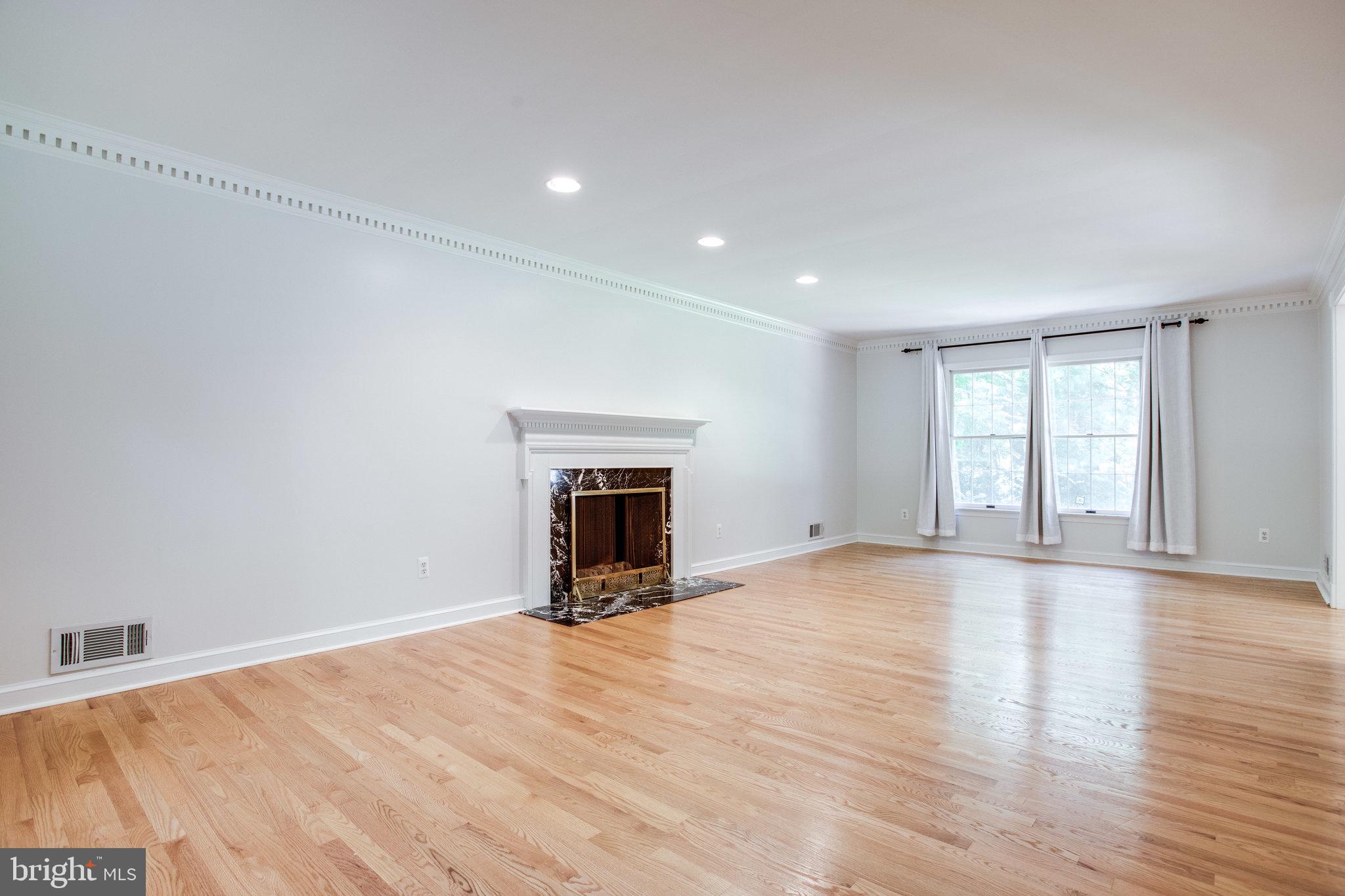 8500 Brook Road McLean, VA 22102 - Photo 5 of 44 a view of an empty room with a window and a fireplace