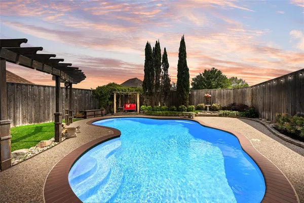 a view of a swimming pool with a lounge chairs