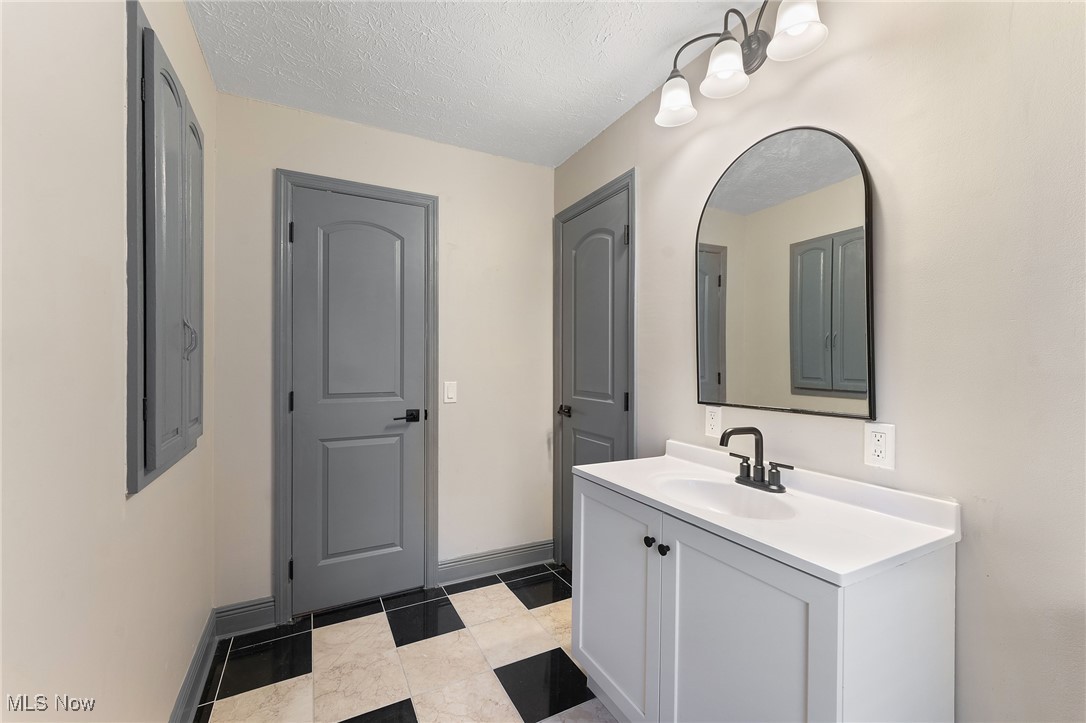 2971 Mogadore Road Akron, OH 44312 - Photo 30 of 45 Bathroom with vanity and a textured ceiling