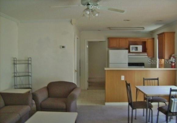 2905 Southwest Archer Road, Unit 4006 Gainesville, FL 32608 - Photo 3 of 8 a living room with furniture and a chandelier