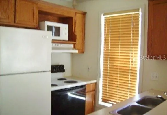 a kitchen with a refrigerator and a window