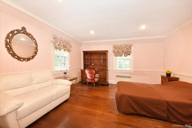 a bedroom with a large bed and a large window