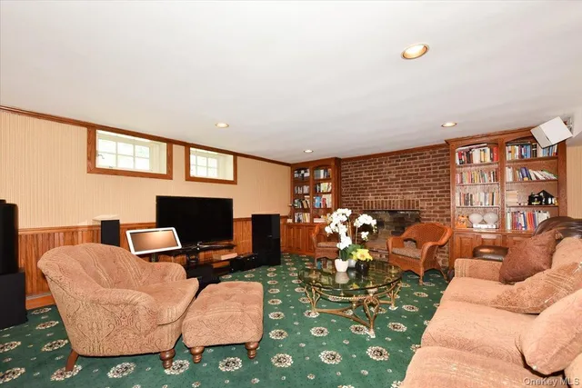 a work room with furniture a rug and a window