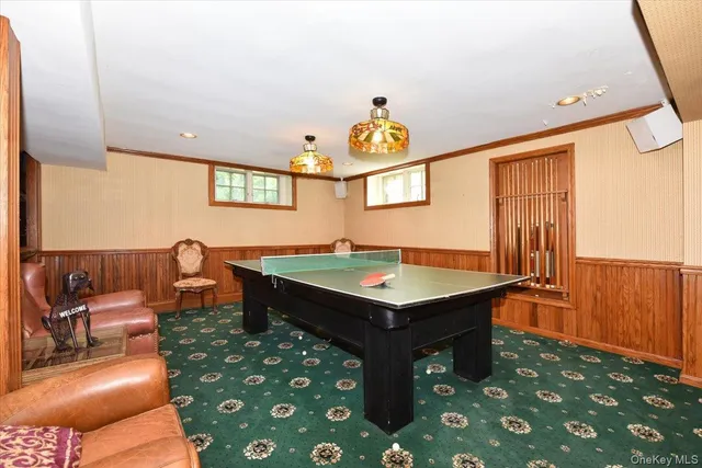a room with furniture pool table and window