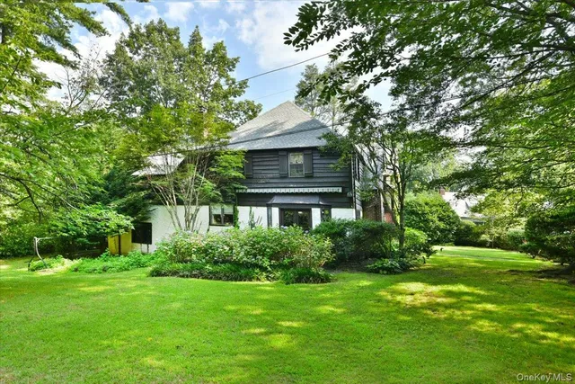 a front view of house with yard and green space
