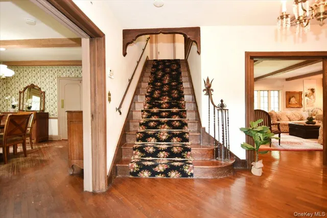 a view of entryway and hall with wooden floor