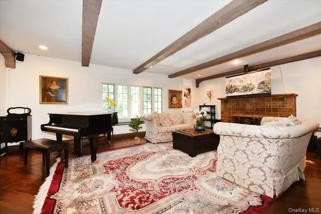 a living room with furniture a rug and a table