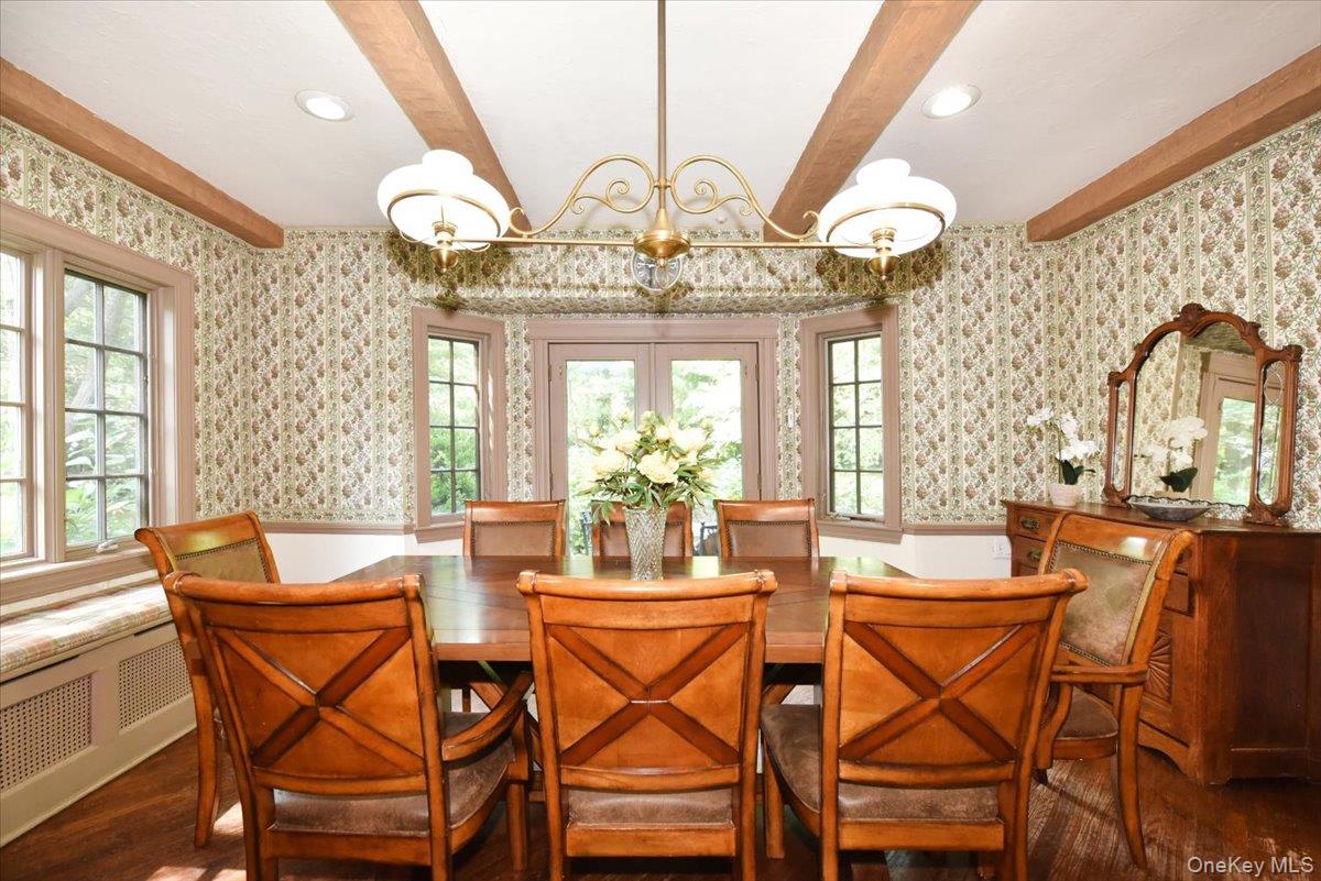 1 Linford Road Great Neck, NY 11021 - Photo 7 of 23 Dining space featuring beamed ceiling, wood finished floors, wallpapered walls, radiator, and recessed lighting