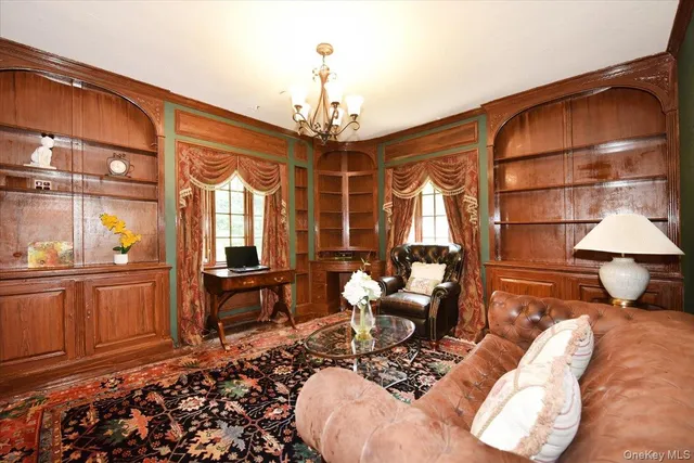 a living room with furniture a window and wooden floor