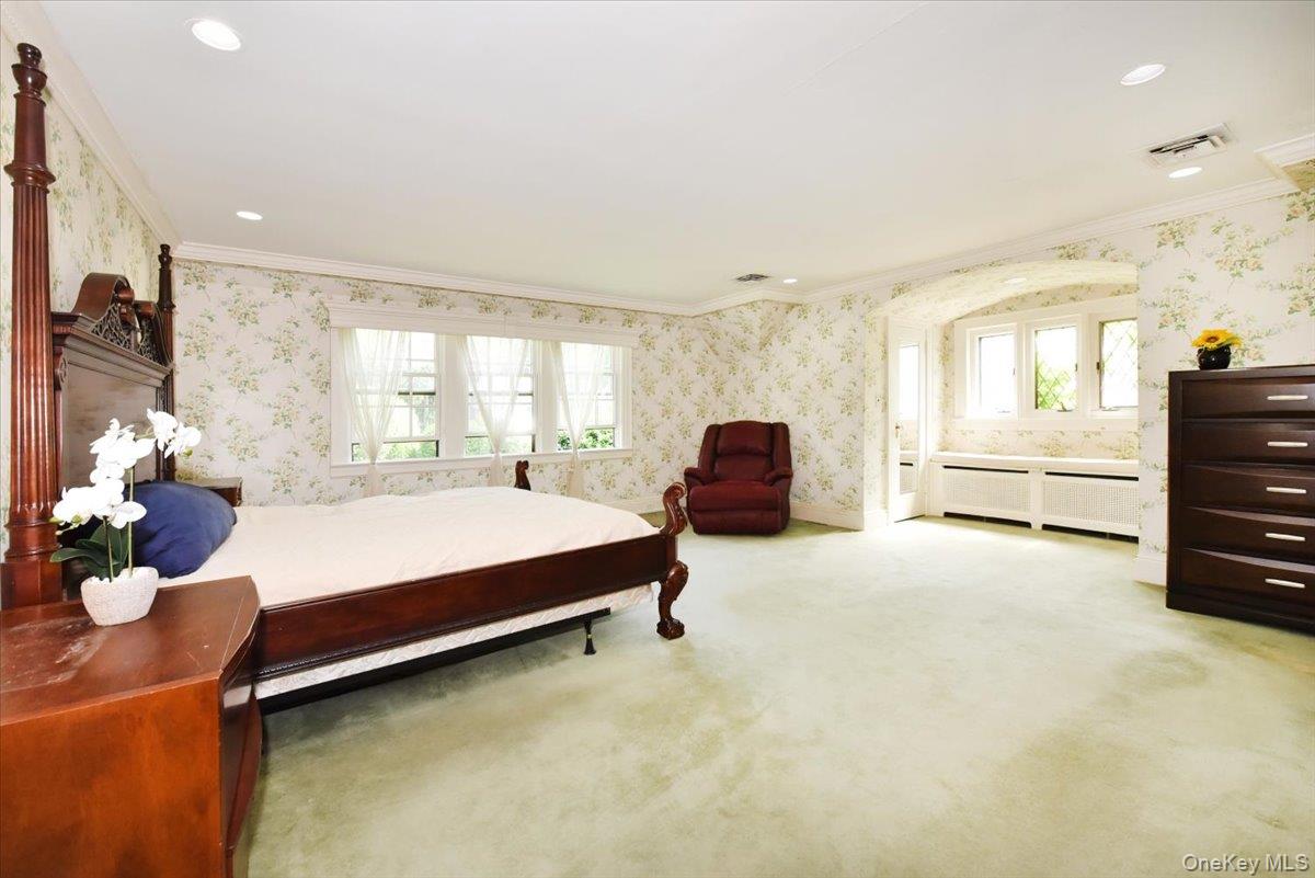 1 Linford Road Great Neck, NY 11021 - Photo 10 of 23 Carpeted bedroom with wallpapered walls, recessed lighting, ornamental molding, and connected bathroom