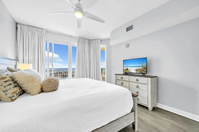 a bedroom with a large bed and a window