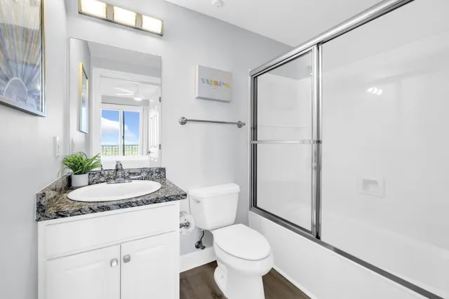 a bedroom with two beds and painting on the wall