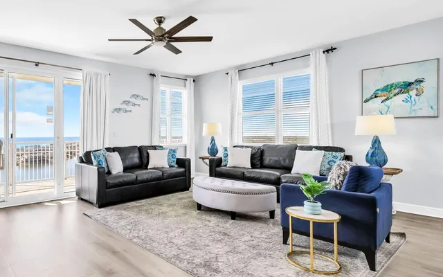 a living room with furniture wooden floor and a large window