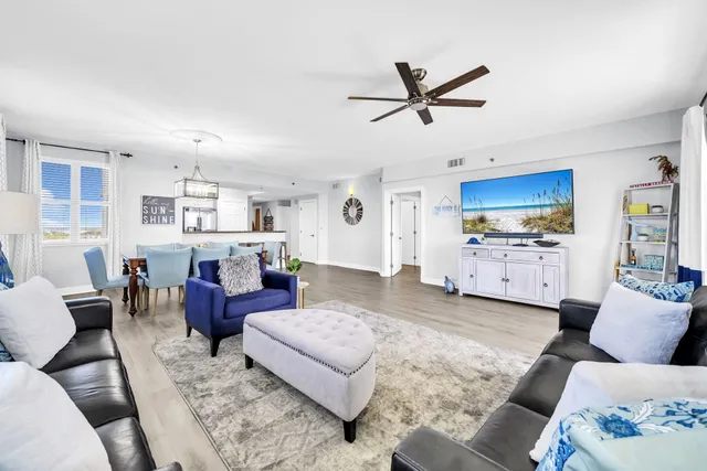a living room with lots of furniture and a chandelier