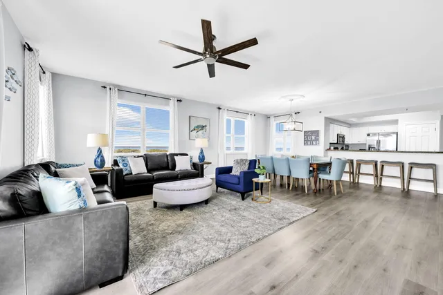 a kitchen with kitchen island white cabinets and stainless steel appliances