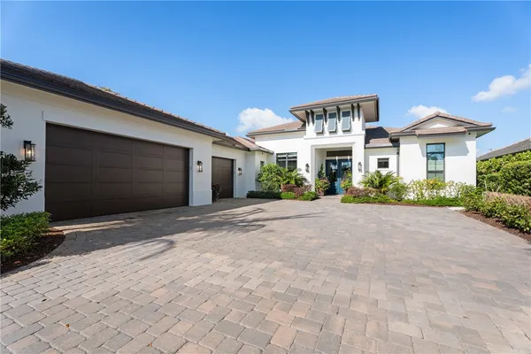a front view of a house with a yard and a garage