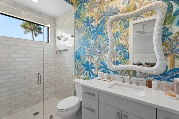 a bathroom with a sink mirror vanity and toilet