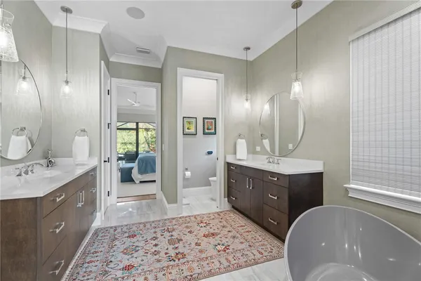 a spacious bathroom with a tub sink shower and mirror