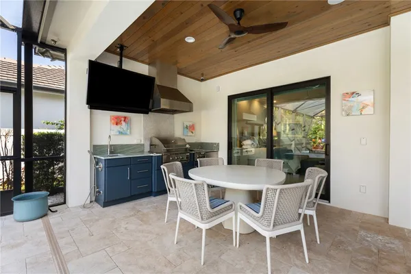 a dining room with furniture a flat screen tv and floor to ceiling window