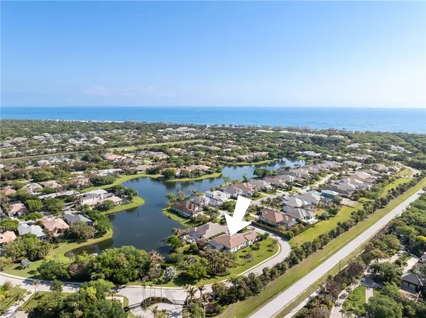 an aerial view of residential building and lake