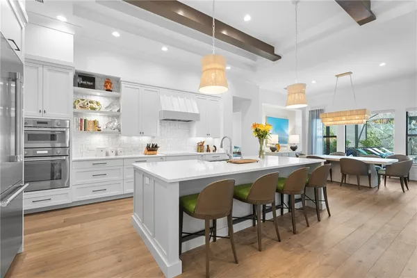a kitchen with lots of wooden furniture appliances and cabinets