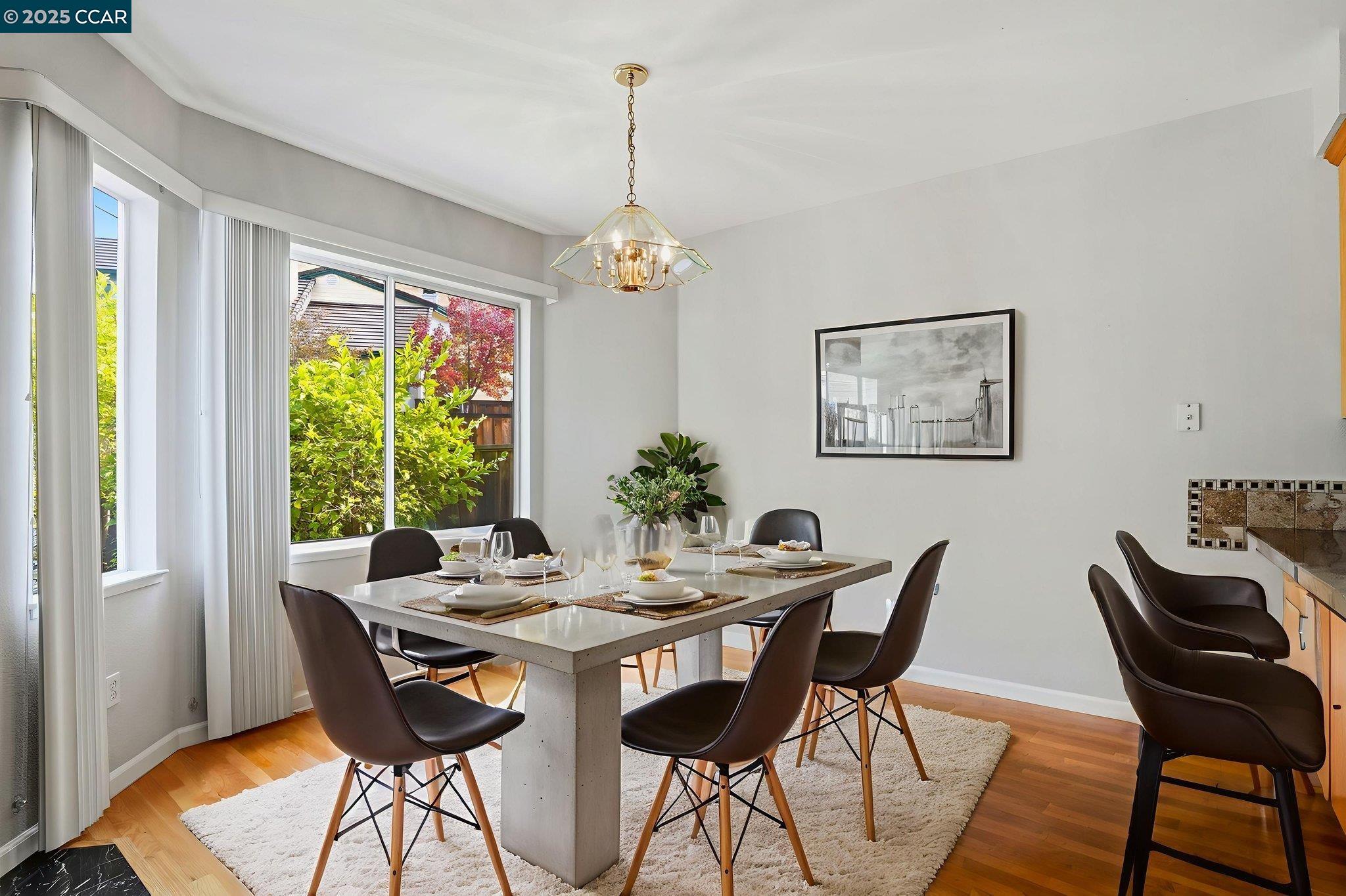 1295 Shell Circle Clayton, CA 94517 - Photo 15 of 36 a dining room with furniture a chandelier and wooden floor