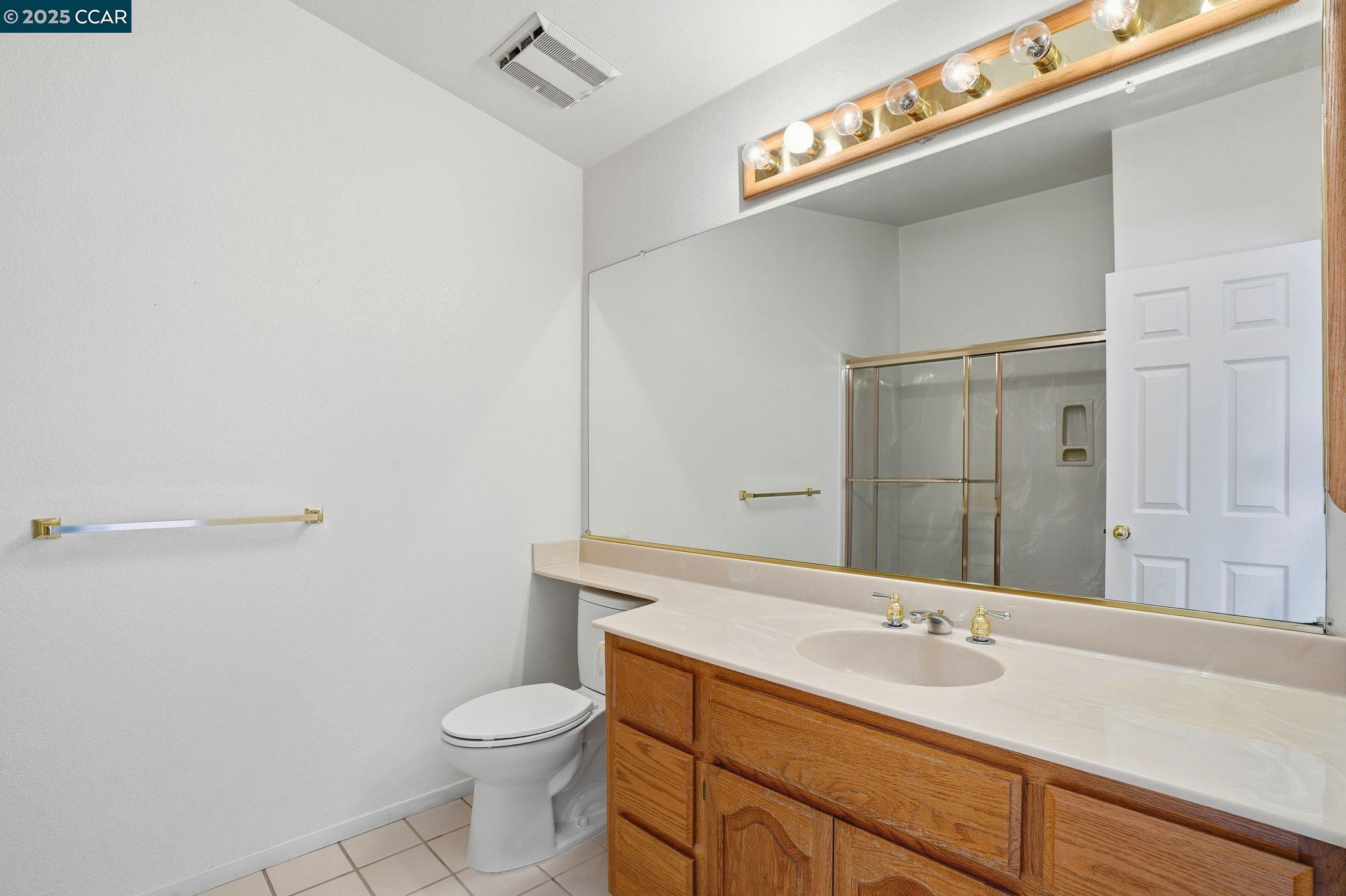 1295 Shell Circle Clayton, CA 94517 - Photo 31 of 36 a bathroom with a granite countertop sink toilet and a mirror