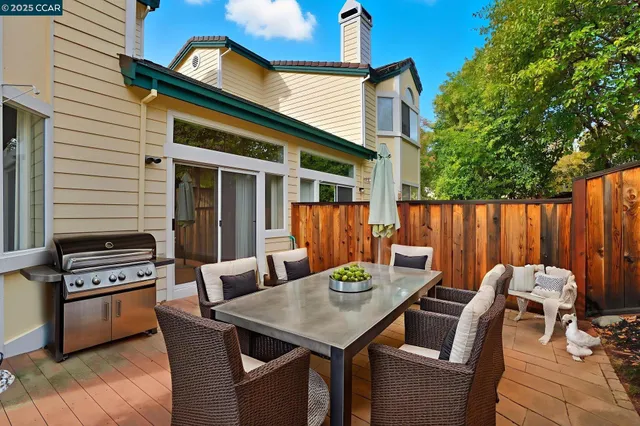 a view of a dinning table and chairs in patio of the house