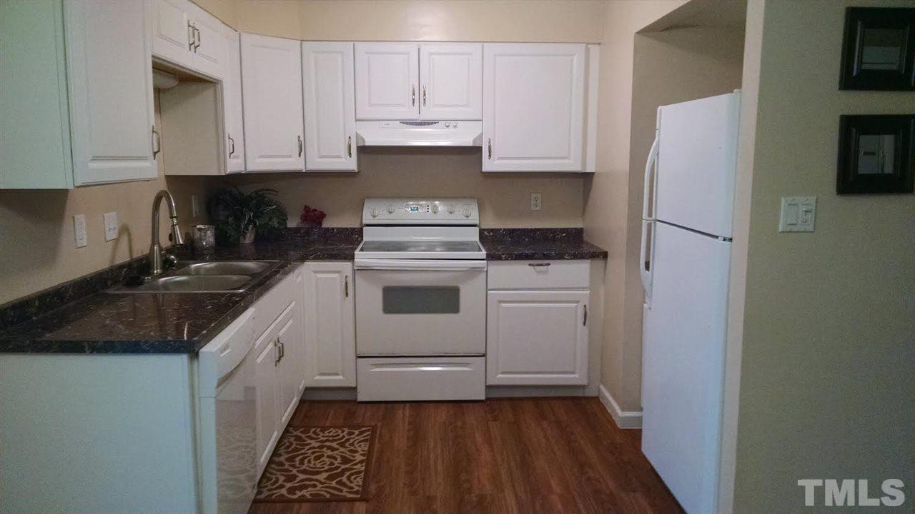 5808 Falls Of Neuse Road, Unit D Raleigh, NC 27609 - Photo 1 of 6 a kitchen with white cabinets and white appliances