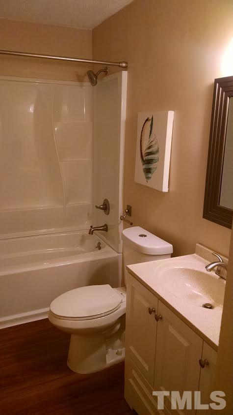 5808 Falls Of Neuse Road, Unit D Raleigh, NC 27609 - Photo 4 of 6 a bathroom with a sink a toilet and shower
