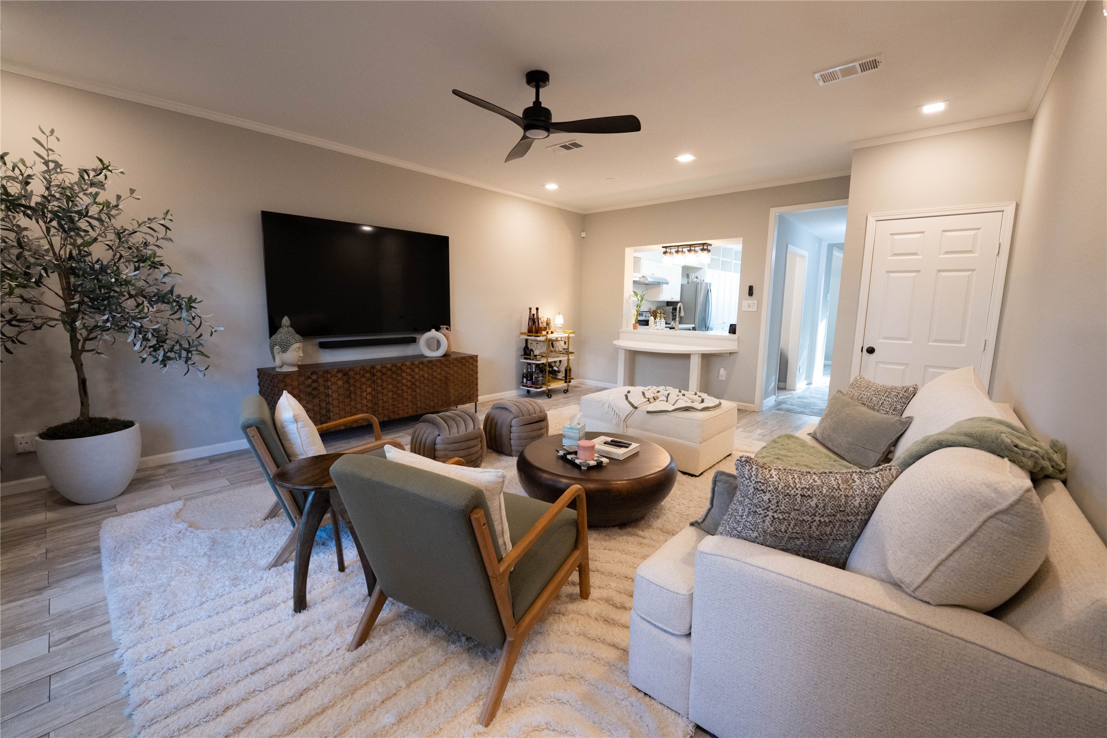 7447 Brompton Street, Unit 7447 Houston, TX 77025 - Photo 6 of 27 Bright, cozy living room with hardwood flooring and a lovely view of the private back patio.