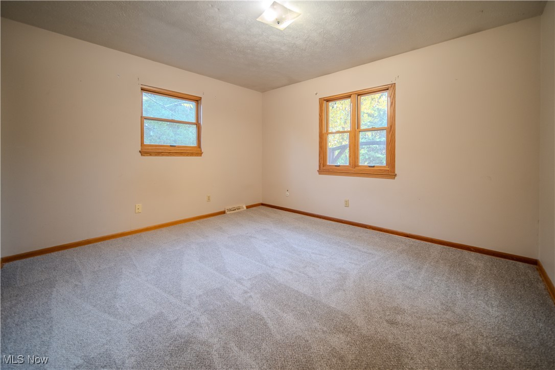 1206 Dussel Road Kent, OH 44240 - Photo 19 of 28 Carpeted spare room featuring healthy amount of natural light and a textured ceiling