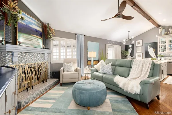 a living room with furniture and a chandelier
