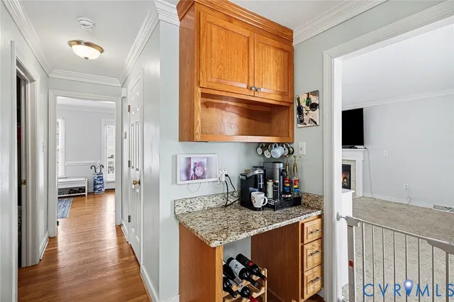 a kitchen with granite countertop a stove top oven microwave and cabinets