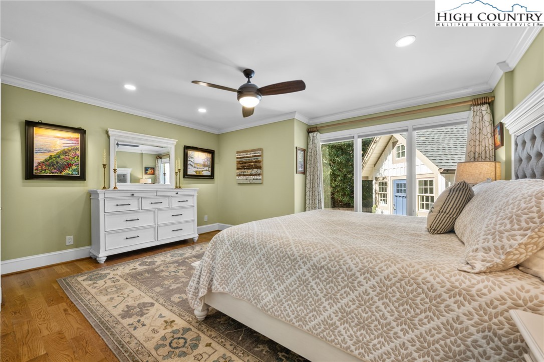 129 Valley View Road Blowing Rock, NC 28605 - Photo 17 of 45 a bedroom with a large bed and wooden floor