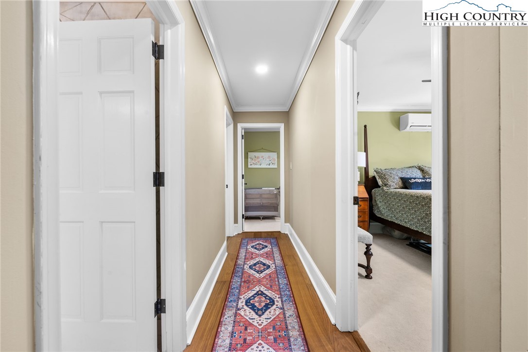 129 Valley View Road Blowing Rock, NC 28605 - Photo 26 of 45 a view of hallway with wooden floor and a bathroom