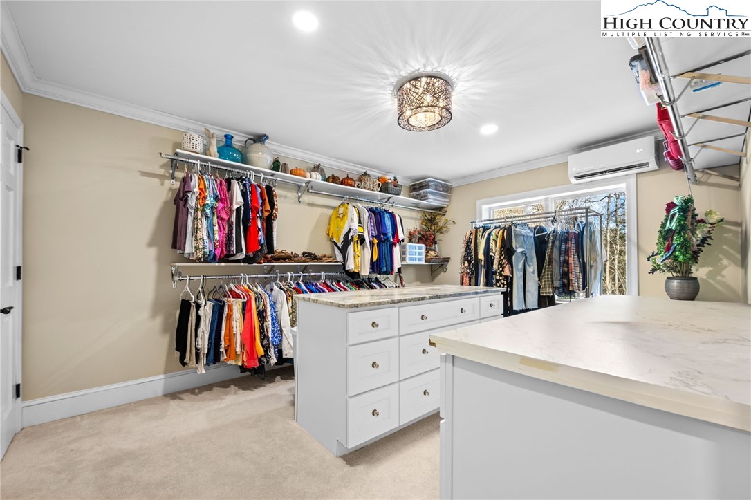 129 Valley View Road Blowing Rock, NC 28605 - Photo 29 of 45 a view of walk in closet with clothes shoes and a mirror