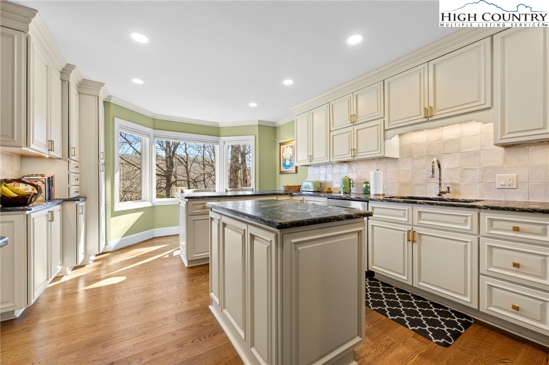 129 Valley View Road Blowing Rock, NC 28605 - Photo 10 of 45 a kitchen with granite countertop white cabinets and white appliances