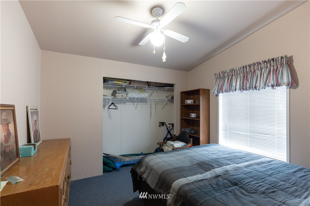 35909 Old Sultan-Startup Road Sultan, WA 98294 - Photo 15 of 22 a bedroom with a bed and a chandelier