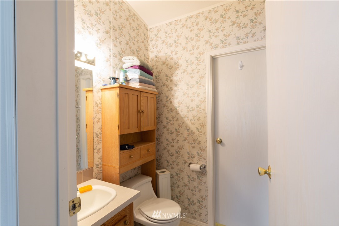 35909 Old Sultan-Startup Road Sultan, WA 98294 - Photo 16 of 22 a bathroom with a granite countertop toilet and a sink
