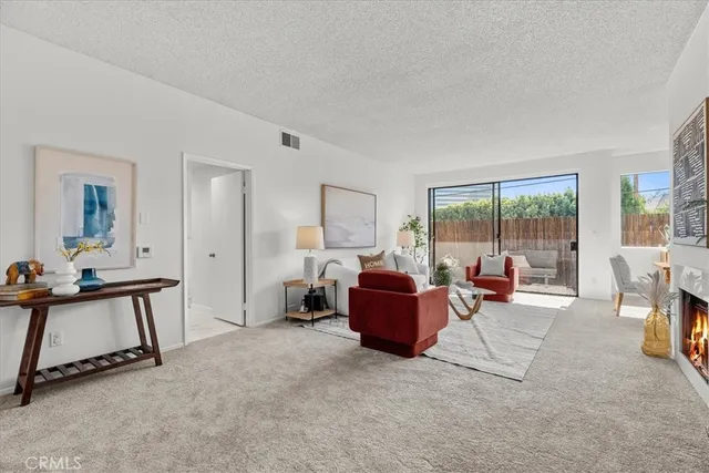 a living room with furniture a flat screen tv and a large window