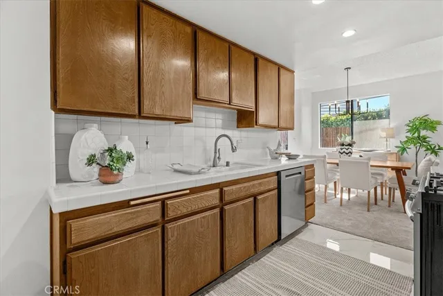 a kitchen with stainless steel appliances granite countertop sink stove and cabinets