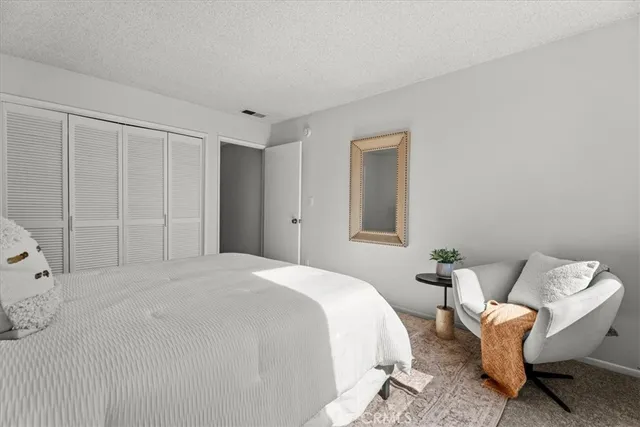 a spacious bedroom with a bed and a window