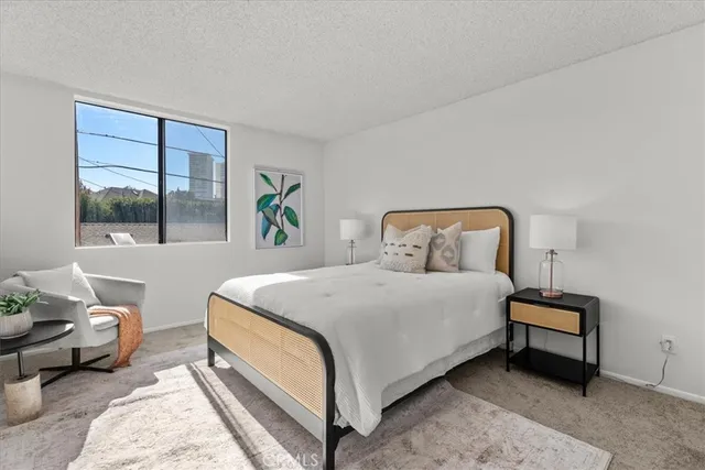 a bedroom with a bed and a window